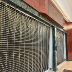 Shuttered,Storefront,With,Metal,Security,Grille,At,Dead,Shopping,Mall