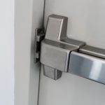 Closed up latch and door handle of emergency exit. Push bar and rail for panic exit. Holzer Commercial Doors, Panic Hardware, Exit Hardware, Emergency Egress, Fire Doors and Fire Door Hardware